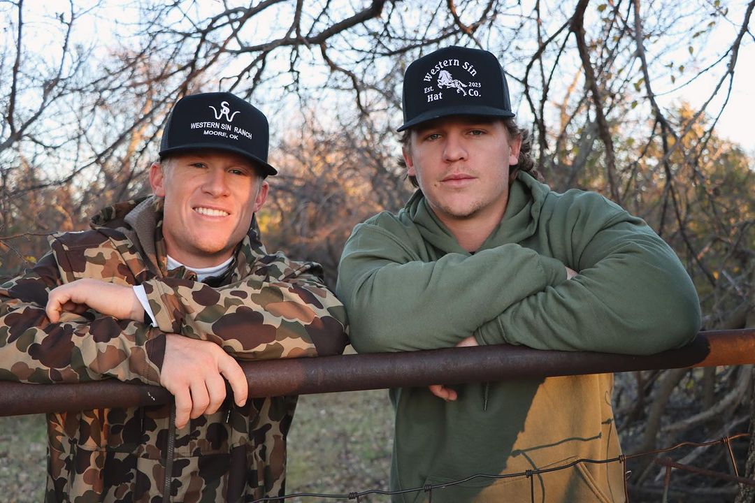 Trucker hats front with people on a fence