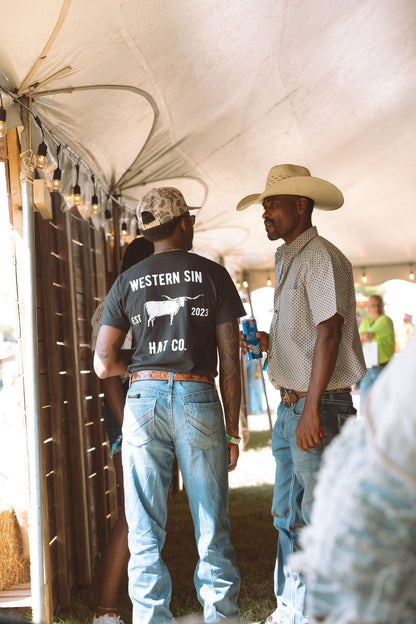 All hat no cattle back of t-shirt wearing it